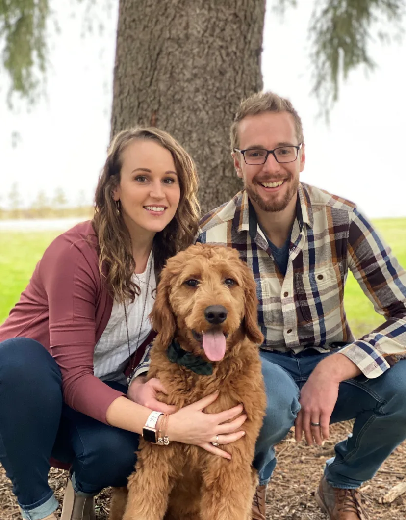 Dr. Alyssa Smith's staff photo from North Lake Veterinary Clinic where she's posing with her husband and pet dog at a park